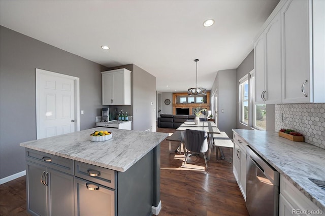 12420 Verbena St, Thornton, CO 80602 - kitchen featuring stainless steel dishwasher, tasteful backsplash, white cabinetry, dark wood-style flooring, and recessed lighting