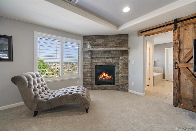 12420 Verbena St, Thornton, CO 80602 - living area with light colored carpet, a barn door, a fireplace, recessed lighting, and light tile patterned floors