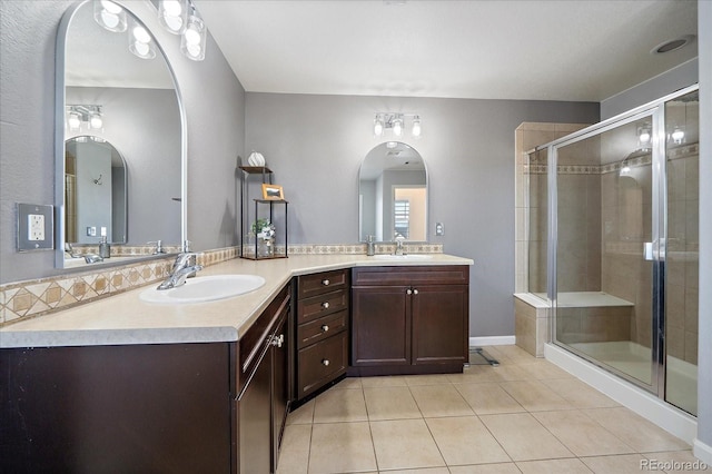 12420 Verbena St, Thornton, CO 80602 - bathroom with tile patterned floors, double vanity, and a stall shower