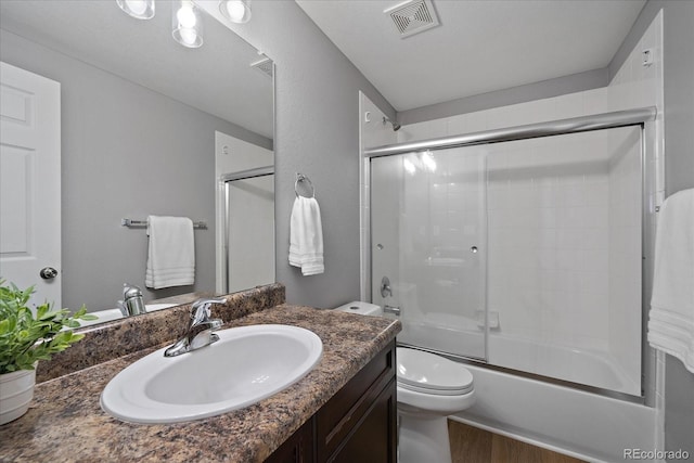 12420 Verbena St, Thornton, CO 80602 - full bath featuring vanity, bath / shower combo with glass door, and wood finished floors