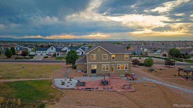 12420 Verbena St, Thornton, CO 80602 - view of front of house with a residential view, a mountain view, and a patio area