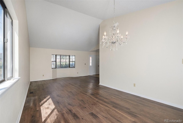 unfurnished room featuring vaulted ceiling, dark hardwood / wood-style floors, and an inviting chandelier