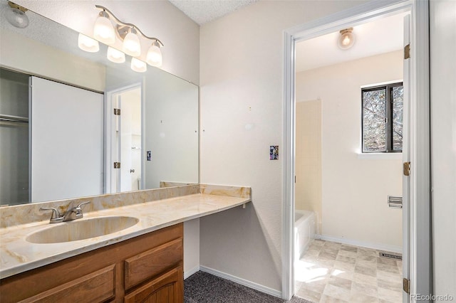 bathroom featuring a textured ceiling, oversized vanity, and tile flooring