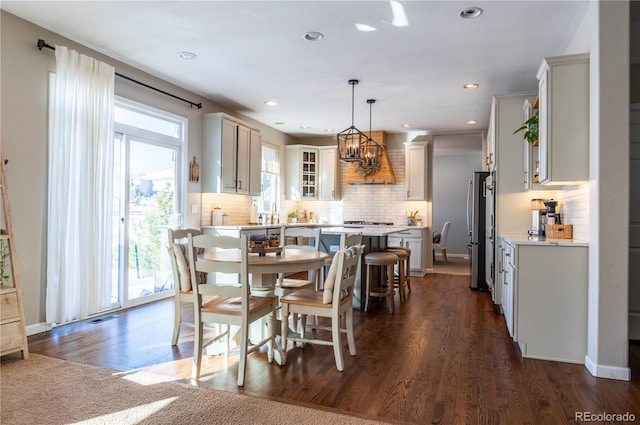 dining area featuring dark hardwood / wood-style floors and an inviting chandelier