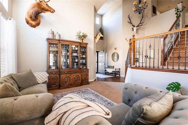 living room with carpet flooring and a high ceiling