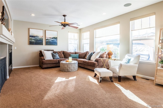 carpeted living room with ceiling fan