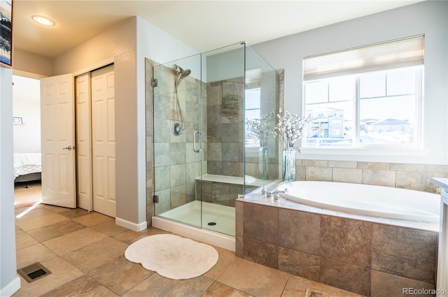 bathroom featuring shower with separate bathtub