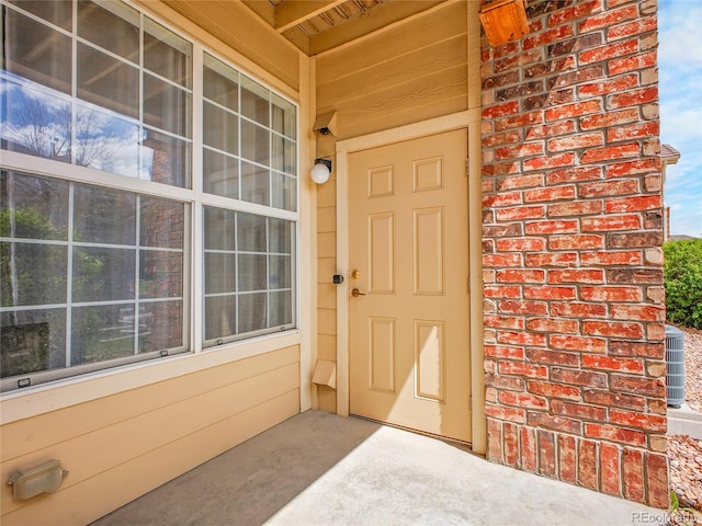 5765 N Genoa Way Unit 1-103, Aurora, CO 80019 - view of exterior entry with brick siding and cooling unit
