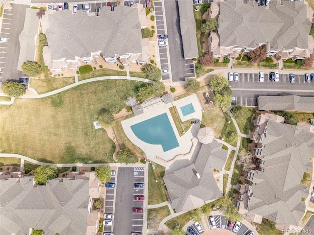 5765 N Genoa Way Unit 1-103, Aurora, CO 80019 - aerial view of property and surrounding area featuring nearby suburban area and a pool area
