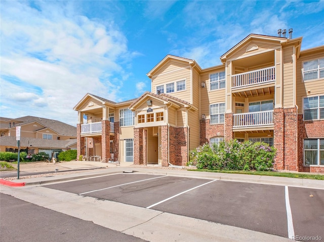 5765 N Genoa Way Unit 1-103, Aurora, CO 80019 - view of building exterior featuring uncovered parking