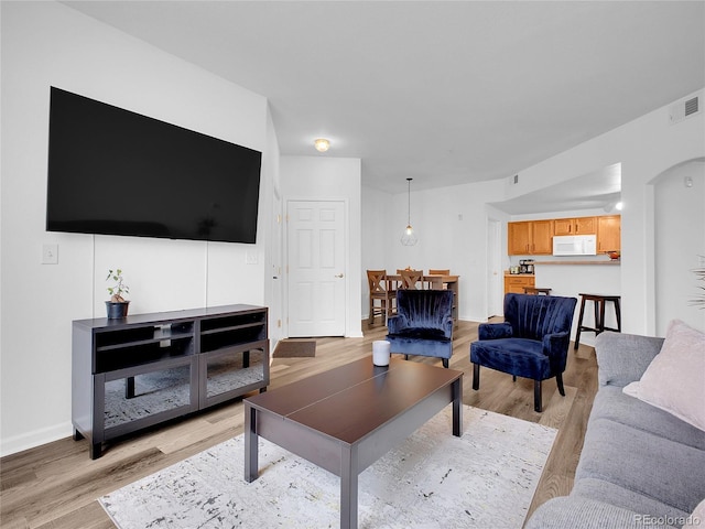5765 N Genoa Way Unit 1-103, Aurora, CO 80019 - living room featuring light wood-style flooring and baseboards
