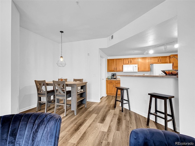 5765 N Genoa Way Unit 1-103, Aurora, CO 80019 - dining room with light wood-style floors and baseboards