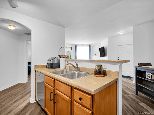 5765 N Genoa Way Unit 1-103, Aurora, CO 80019 - kitchen with a sink, dishwasher, dark wood-style floors, light countertops, and brown cabinetry