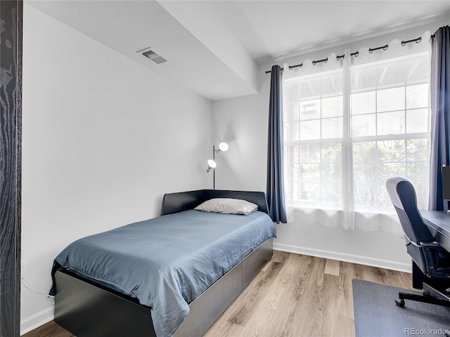 5765 N Genoa Way Unit 1-103, Aurora, CO 80019 - bedroom featuring wood finished floors, baseboards, and an office area