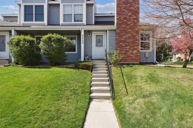 8220 W 90th Pl Unit 2003, Broomfield, CO 80021 - view of front of home with a front lawn and a chimney