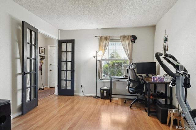 8220 W 90th Pl Unit 2003, Broomfield, CO 80021 - home office with french doors, wood finished floors, a textured ceiling, and baseboards