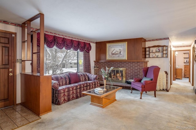 living room with light colored carpet, wooden walls, and a brick fireplace