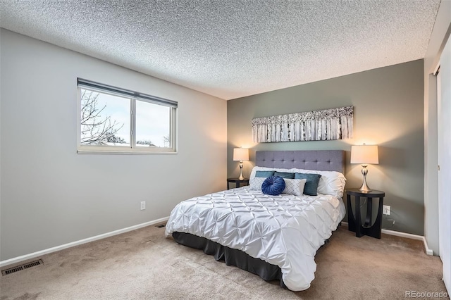 carpeted bedroom featuring a textured ceiling