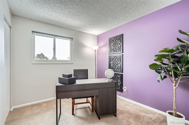 office area with light carpet and a textured ceiling