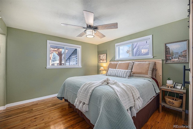 bedroom with dark hardwood / wood-style floors and ceiling fan