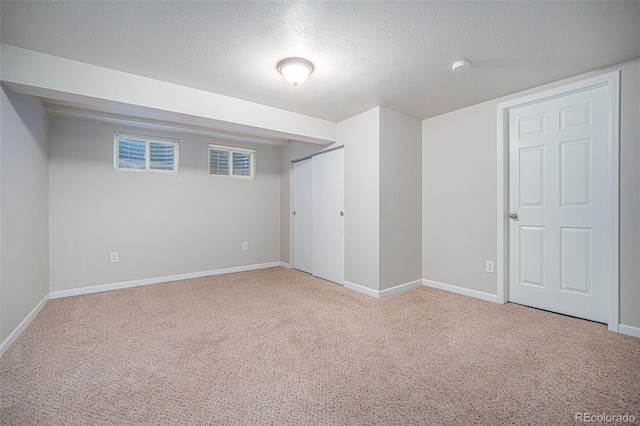 basement with carpet flooring and a textured ceiling