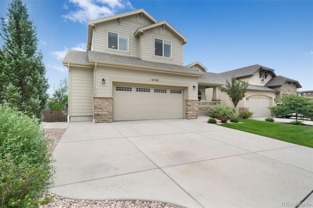 9135 Argentine Pass Trl, Colorado Springs, CO 80924 - view of front of home featuring an attached garage, driveway, stone siding, and a shingled roof