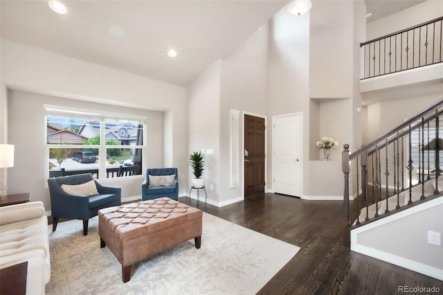 9135 Argentine Pass Trl, Colorado Springs, CO 80924 - living room featuring wood finished floors, a towering ceiling, recessed lighting, and stairway