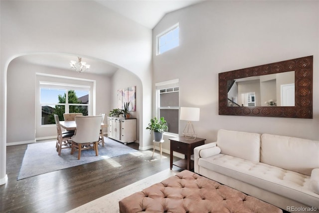 9135 Argentine Pass Trl, Colorado Springs, CO 80924 - living area featuring arched walkways, wood finished floors, a chandelier, and vaulted ceiling