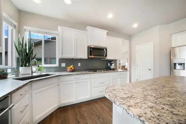 9135 Argentine Pass Trl, Colorado Springs, CO 80924 - kitchen featuring stainless steel appliances, dark wood-style flooring, decorative backsplash, white cabinets, and recessed lighting