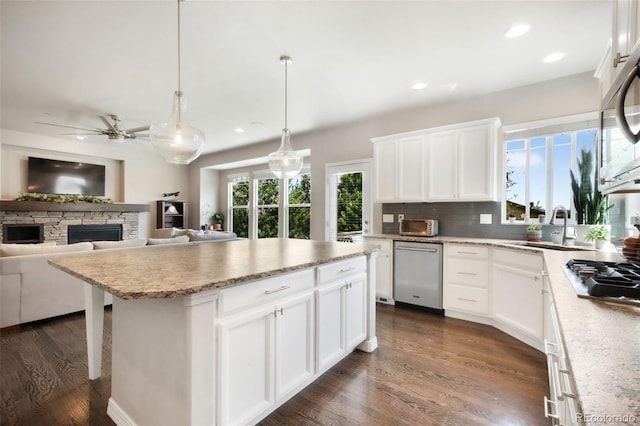9135 Argentine Pass Trl, Colorado Springs, CO 80924 - kitchen with stainless steel appliances, recessed lighting, dark wood-type flooring, a ceiling fan, and decorative backsplash