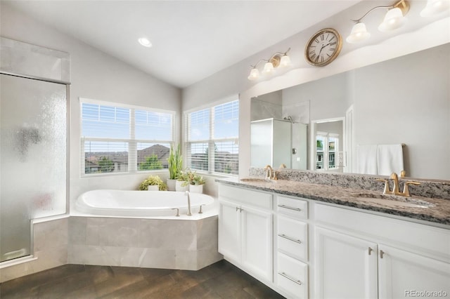 9135 Argentine Pass Trl, Colorado Springs, CO 80924 - full bathroom with a shower stall, a garden tub, double vanity, lofted ceiling, and wood finished floors