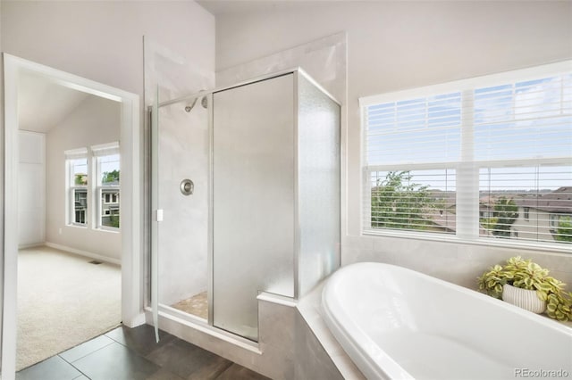 9135 Argentine Pass Trl, Colorado Springs, CO 80924 - full bath featuring tiled tub, tile patterned floors, and a stall shower