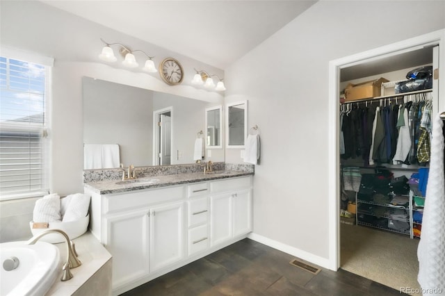 9135 Argentine Pass Trl, Colorado Springs, CO 80924 - full bath featuring double vanity, a relaxing tiled tub, and a spacious closet