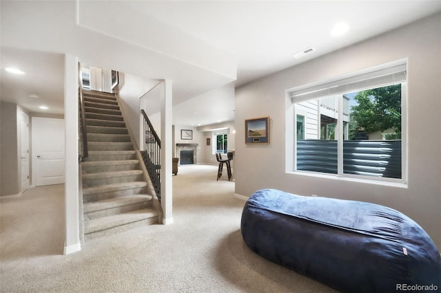 9135 Argentine Pass Trl, Colorado Springs, CO 80924 - staircase featuring carpet, a stone fireplace, and recessed lighting