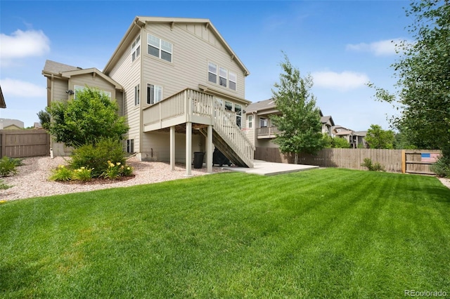 9135 Argentine Pass Trl, Colorado Springs, CO 80924 - back of house featuring a fenced backyard, stairs, a wooden deck, and board and batten siding