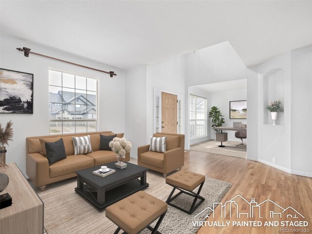 living area featuring light wood-type flooring and baseboards