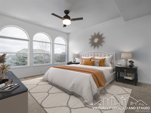 carpeted bedroom with baseboards and a ceiling fan