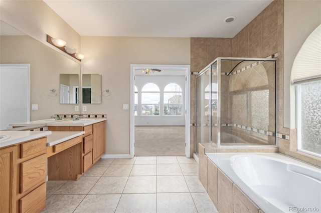 full bath with a shower stall, tile patterned flooring, vanity, and a garden tub