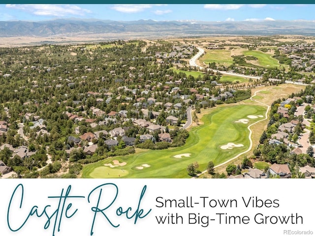 birds eye view of property featuring a mountain view and view of golf course