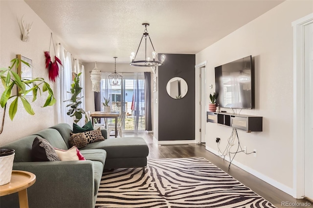 442 Stardust Ct, Dacono, CO 80514 - living room with a notable chandelier, baseboards, and dark wood finished floors