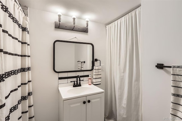 442 Stardust Ct, Dacono, CO 80514 - bathroom with tasteful backsplash, vanity, and a shower with curtain