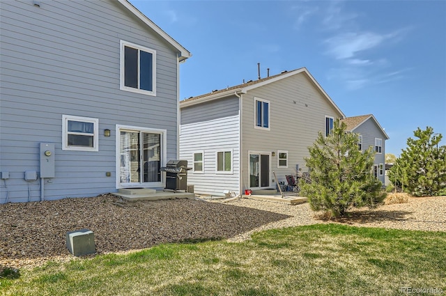 442 Stardust Ct, Dacono, CO 80514 - rear view of house featuring a patio area and a lawn