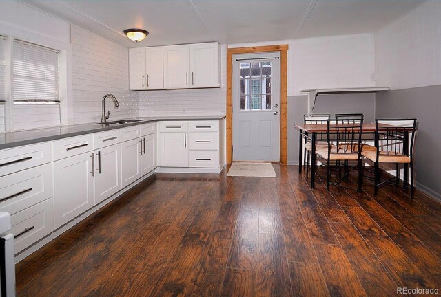 kitchen featuring sink, dark wood-type flooring, and white cabinetry