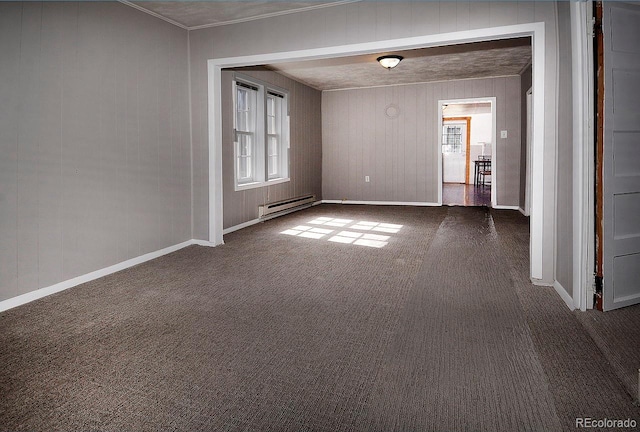 unfurnished room featuring a baseboard heating unit and dark carpet