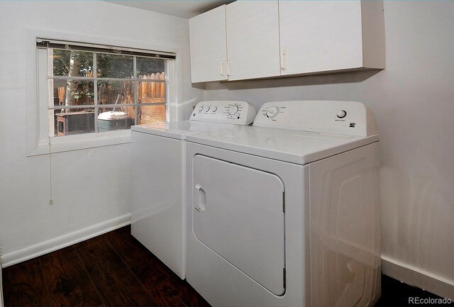 washroom with independent washer and dryer, dark hardwood / wood-style flooring, and cabinets