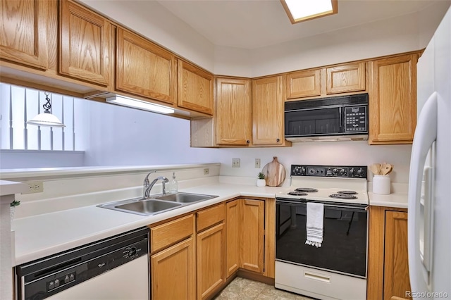 kitchen featuring white appliances, a sink, and light countertops