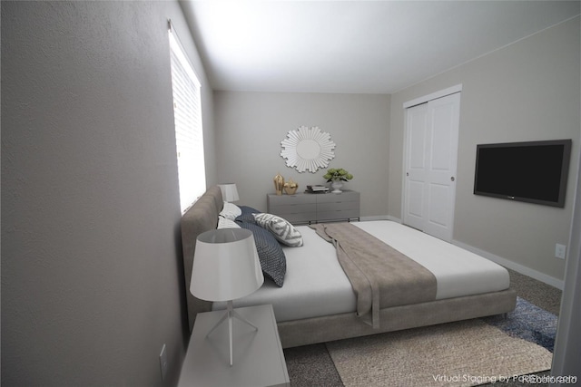 carpeted bedroom with baseboards and a textured wall