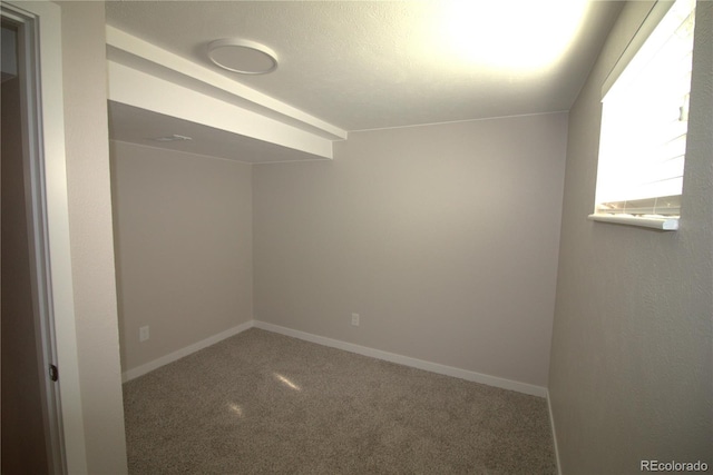 carpeted spare room with baseboards