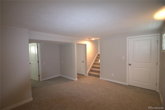 finished below grade area with stairway, carpet, and baseboards