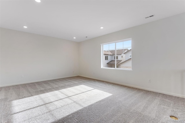 spare room with baseboards, carpet, visible vents, and recessed lighting